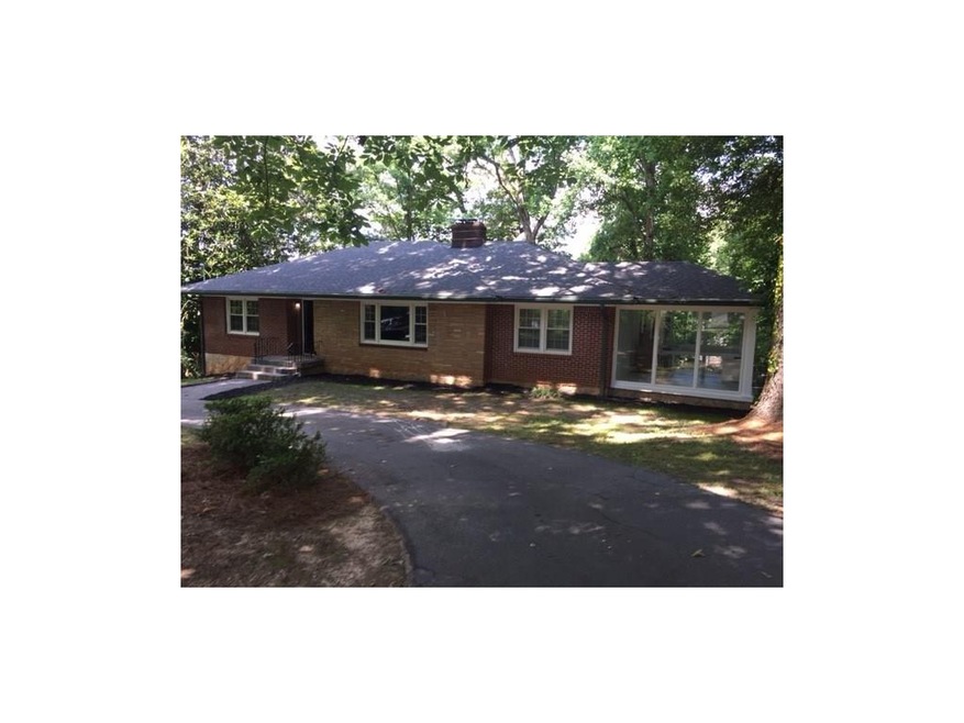 Home sits to the rear of a old treed growth island with circular drive 4 sided brick, new roof, all new thermo pane windows throughout, with deep lot newly seeded and landscaped to the rear
