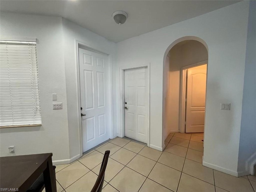 Entrance foyer with light tile patterned floors