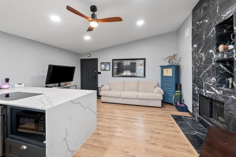 Living room with lofted ceiling, light wood-type 