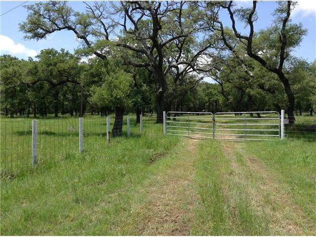 Pipe fence entrance, oak trees