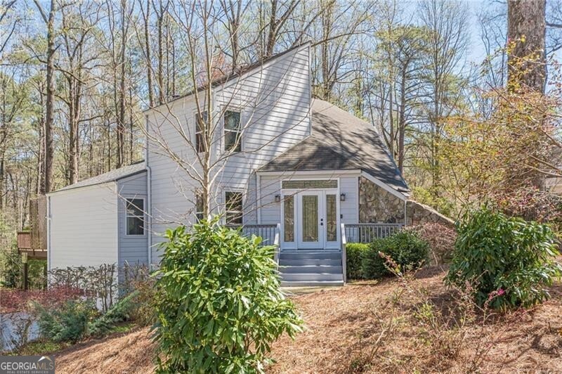 Front view of house with stone & cement siding (no