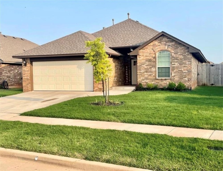 Ranch-style house featuring a garage and a front yard
