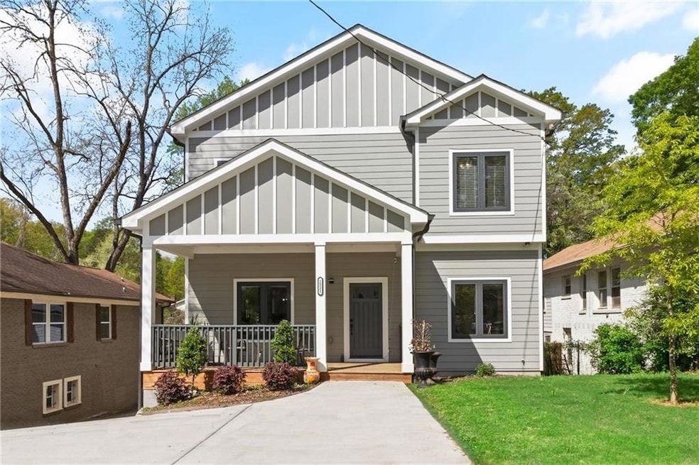 Craftsman-style house with board and batten siding, a porch, and a front lawn