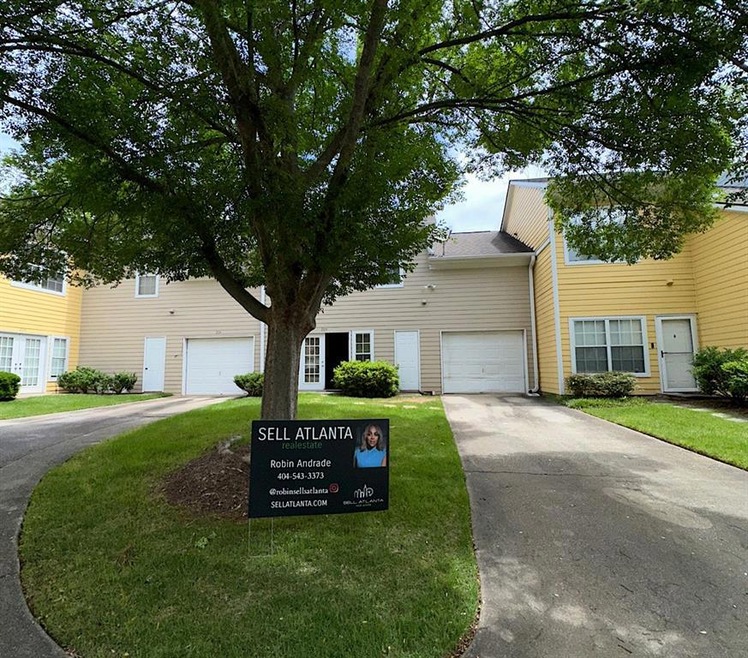 View of front facade with a garage and a front law