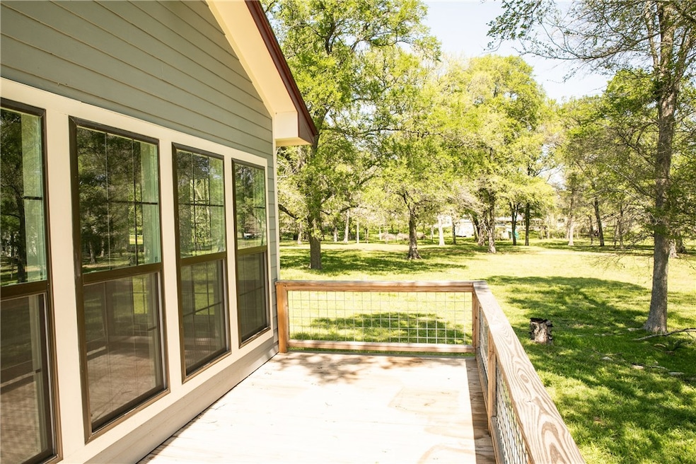 Wooden deck featuring covered porch and a yard