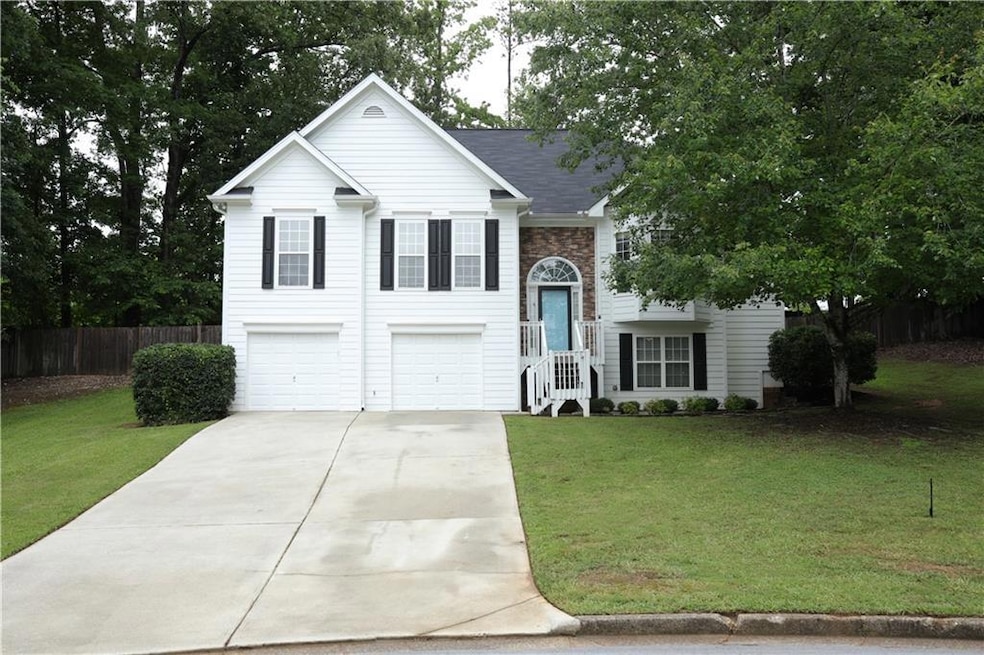 Bi-level home featuring a garage and driveway