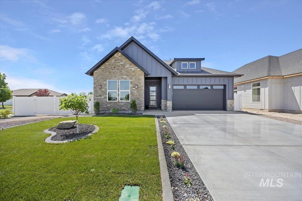 View of front facade featuring board and batten siding, an attached garage, concrete driveway, and stone siding
