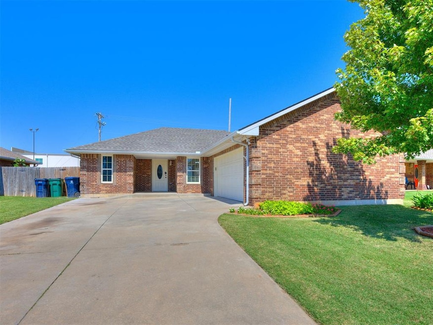Ranch-style home with brick siding, an attached garage, concrete driveway, and roof with shingles