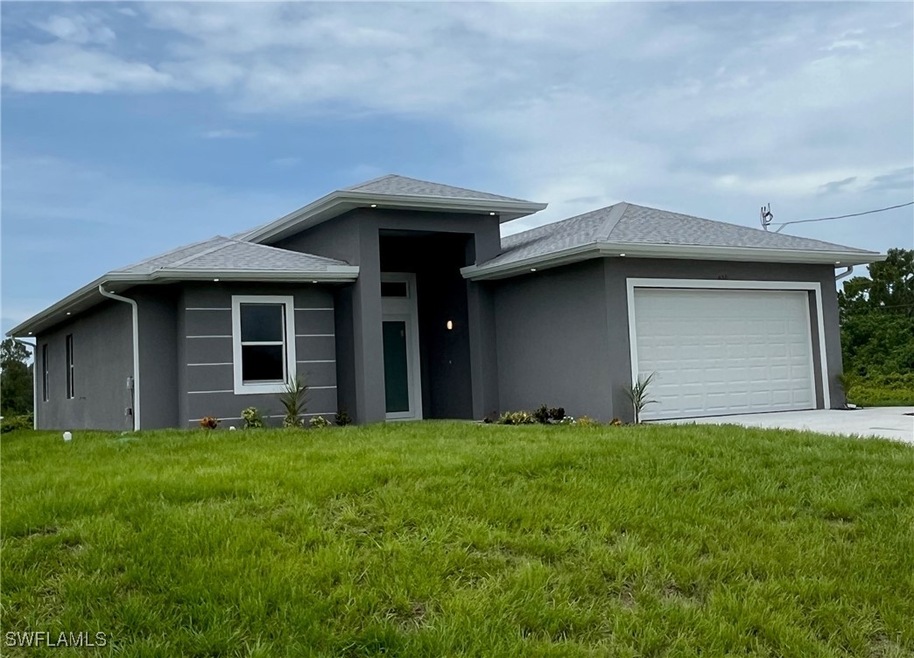 Prairie-style house with stucco siding, a garage,