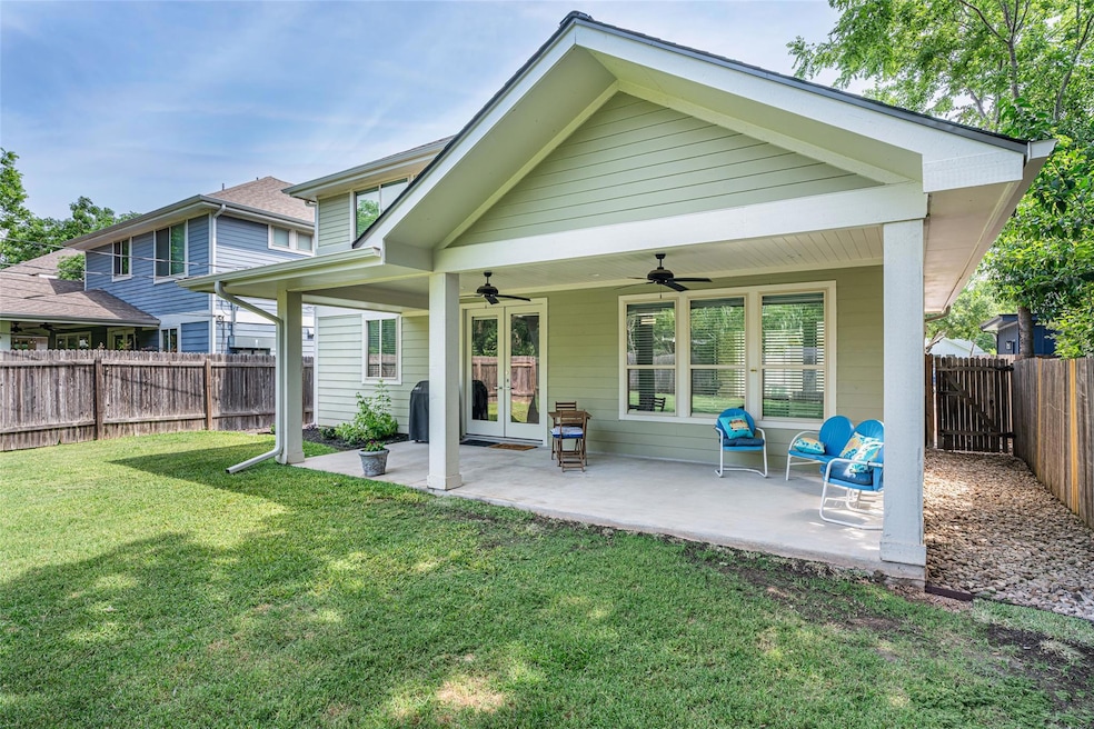 Back of house featuring a ceiling fan, a patio ar