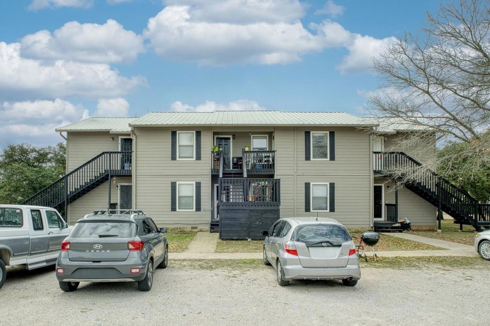 View of front of house featuring stairway, a metal roof, and a balcony