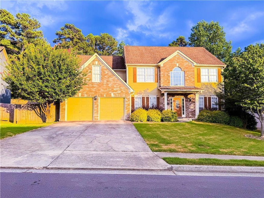 View of front of home with concrete driveway and brick siding