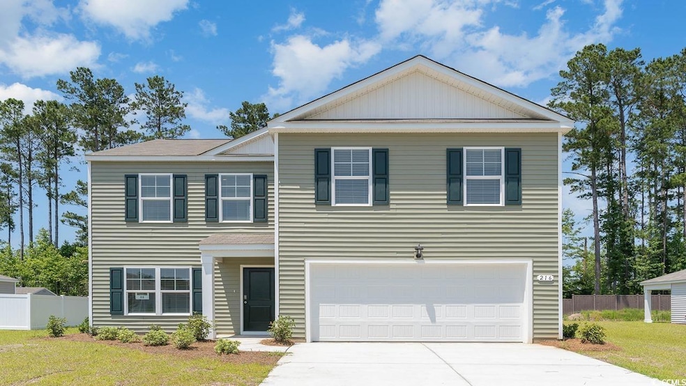 View of front of house featuring a front yard, dri