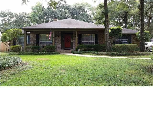 Front of house with beautiful landscaped yard.