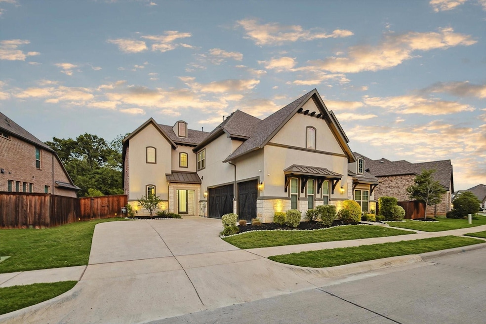 View of front facade with a lawn and a garage