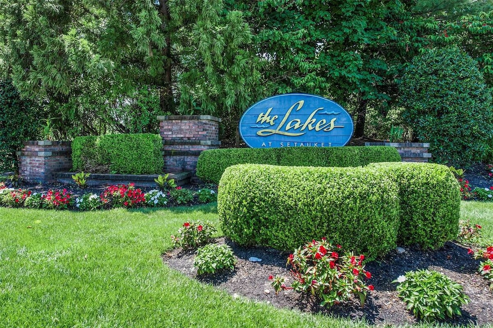 Community / neighborhood sign with a yard