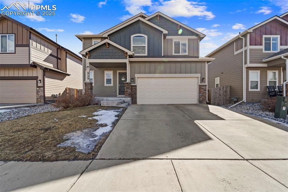 Craftsman-style house with board and batten siding, concrete driveway, stone siding, and an attached garage