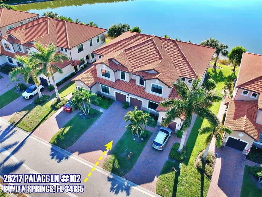 Birds eye view of property with a water view