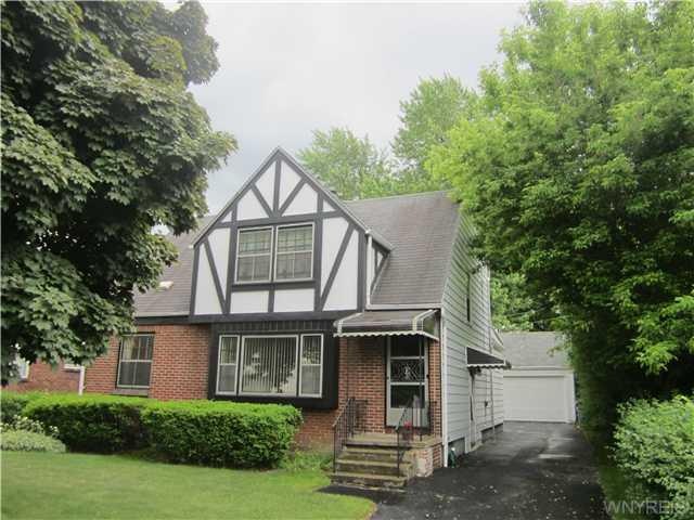 Exterior Front. Tudor style brick + alum sided 2/1