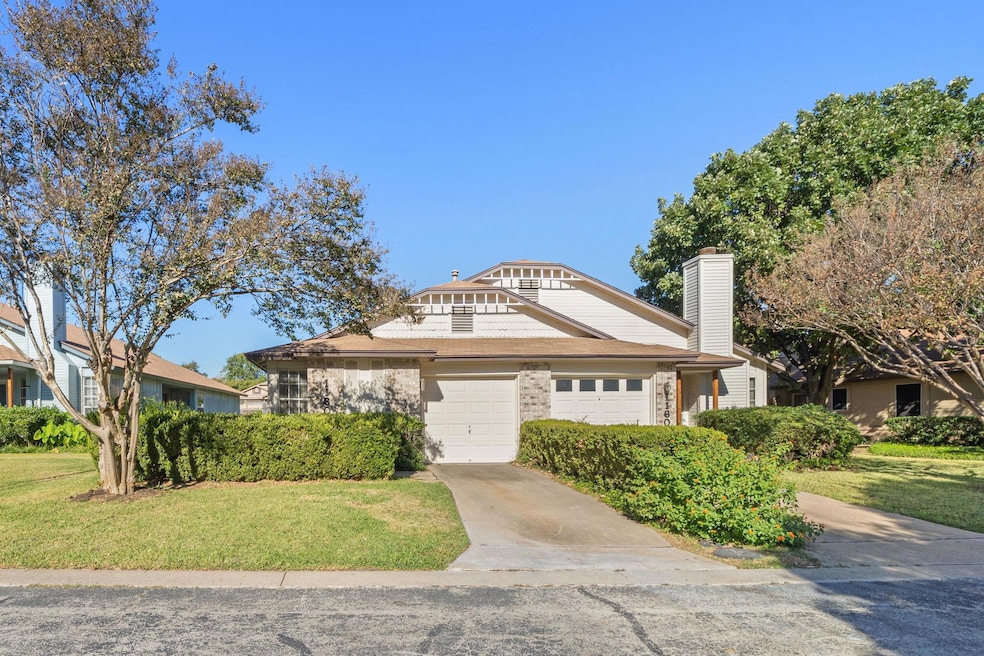View of front of house with concrete driveway, a chimney, and a front yard
