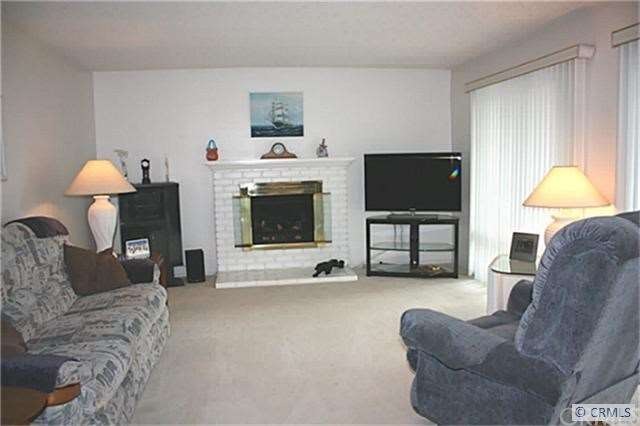 LIVING ROOM WITH WOOD BURNING FIRE PLACE THAT HAS 