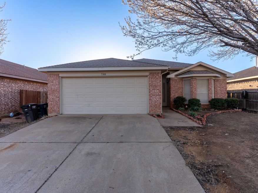 Ranch-style house with an attached garage, fence, 