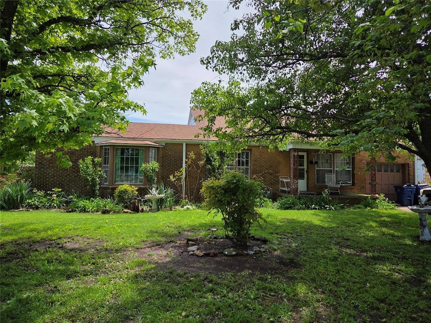 Ranch-style house with brick siding and a front la