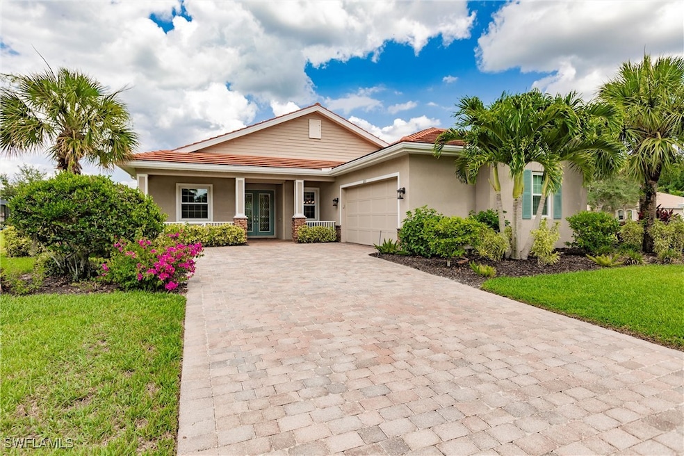 View of front facade featuring a porch, a garage,