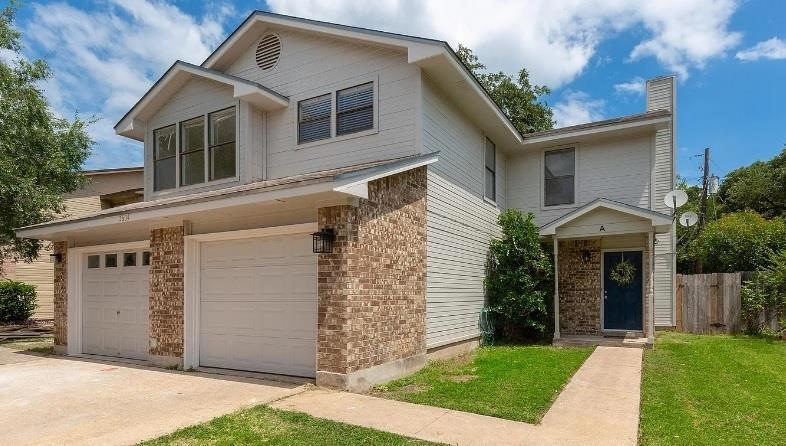 View of front facade featuring an attached garage