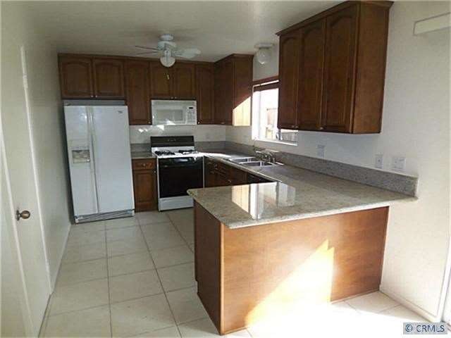 Big Kitchen with Granite Countertops and Refrigerator