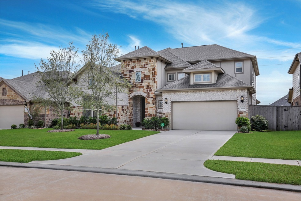 Built by Lennar, this stunning brick and stone elevation is accented by gorgeous landscaping, impeccably manicured lawn, and sprinkler system. High & dry - no flooding.
