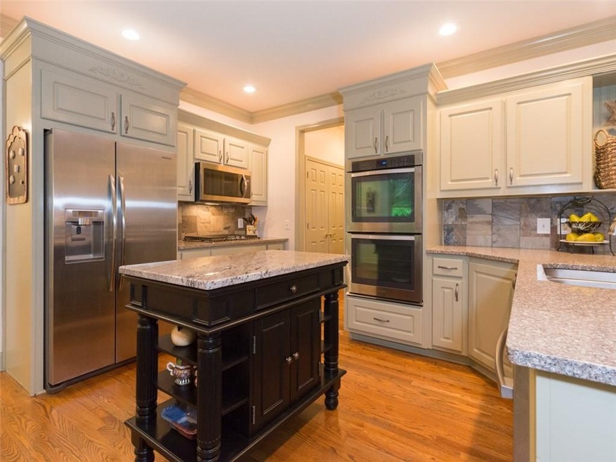 Trend right kitchen with painted cabinets, granite