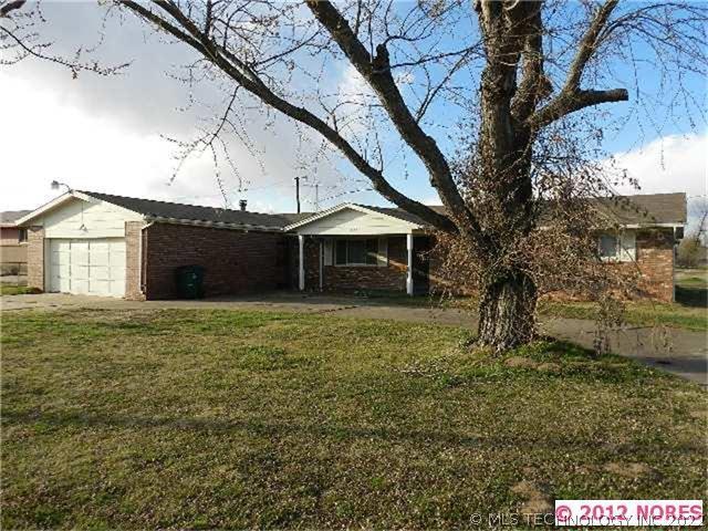 This one-story, full brick home sits on over three