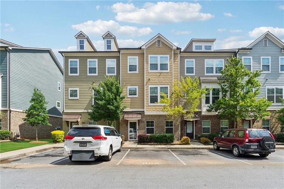 Multi unit property featuring uncovered parking and brick siding