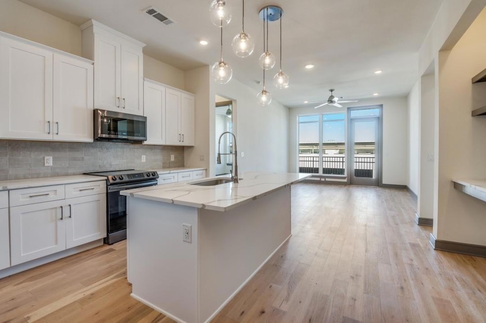 Kitchen featuring white cabinetry, sink, a kitchen