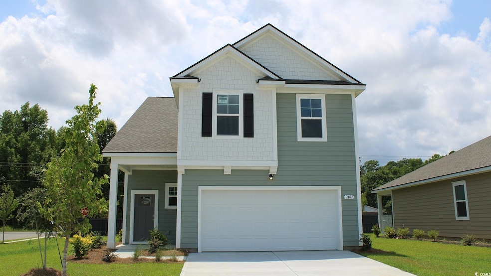 Craftsman house with a front lawn, an attached gar