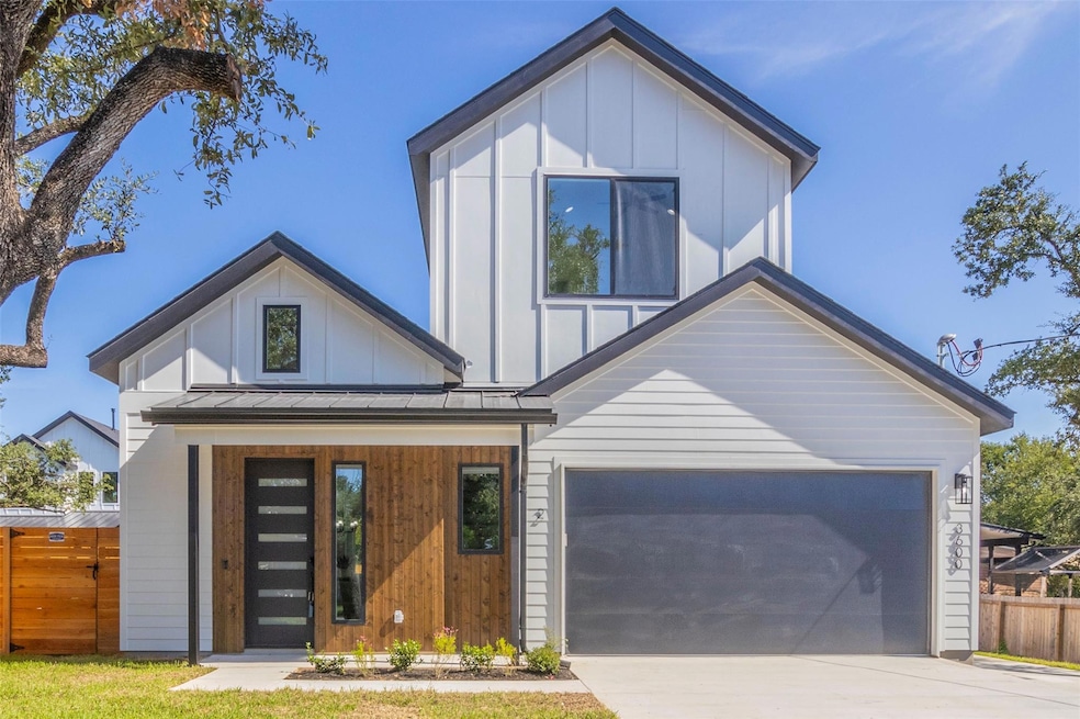 View of front of home featuring board and batten siding, driveway, a porch, a metal roof, and a garage