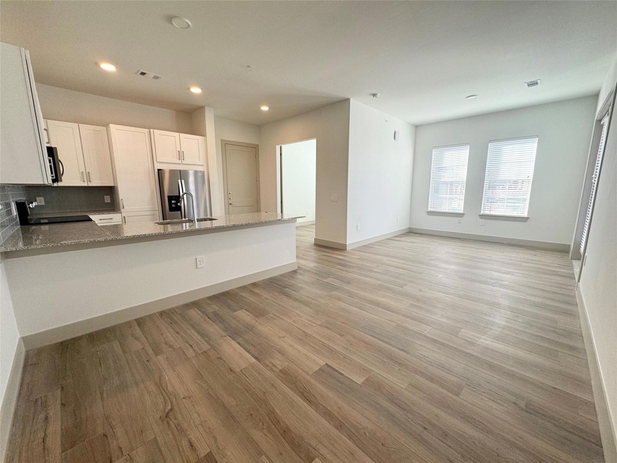 Kitchen featuring range, white cabinets, sink, sta