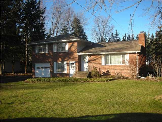 Exterior Front Mature lot with several trees and l
