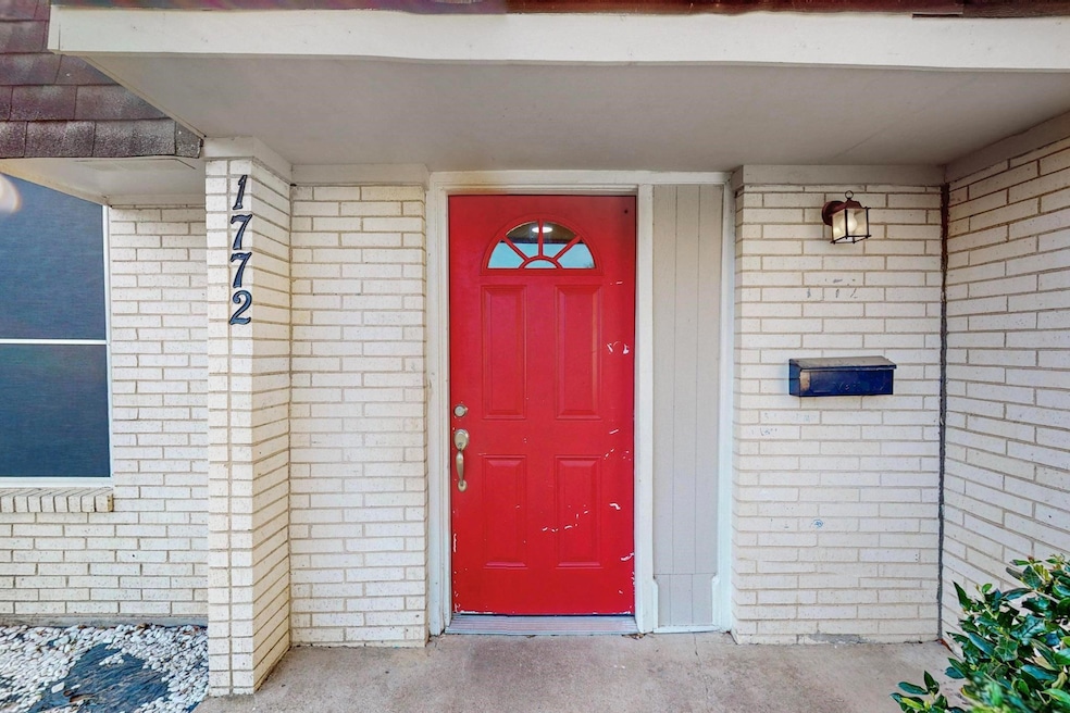 Doorway to property with brick siding
