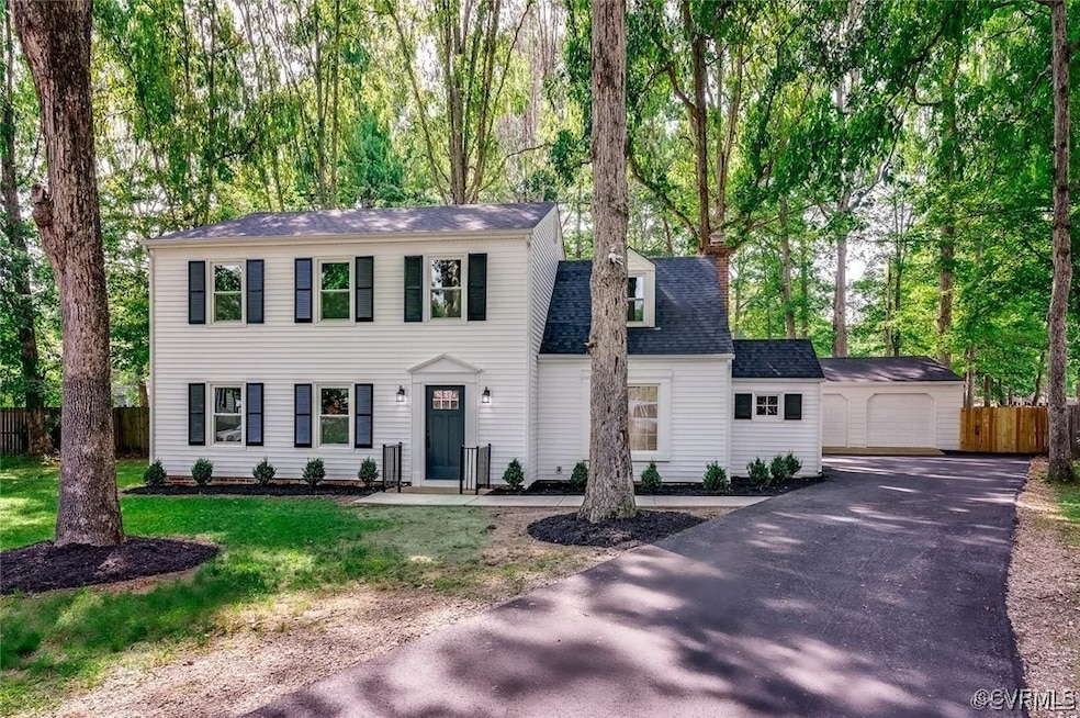Colonial-style house with an outbuilding, a front