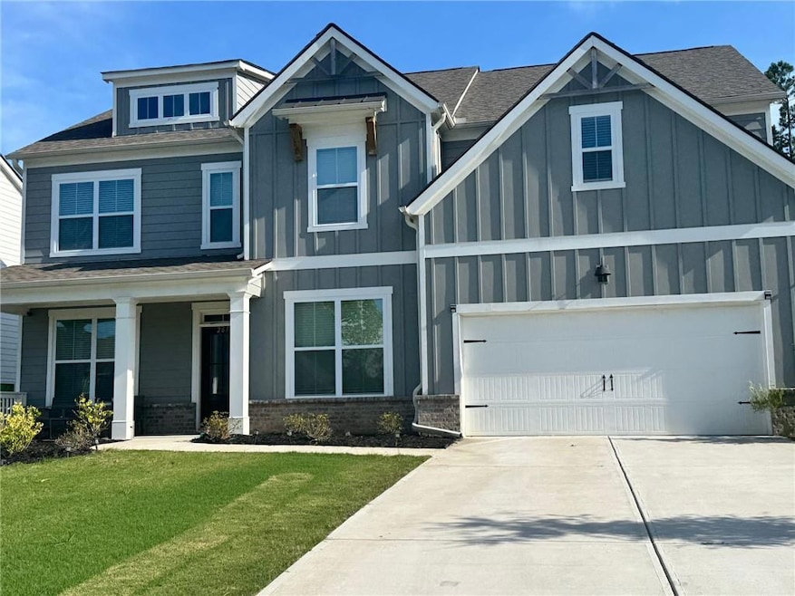 Craftsman inspired home featuring board and batten siding, concrete driveway, a front lawn, brick siding, and a shingled roof