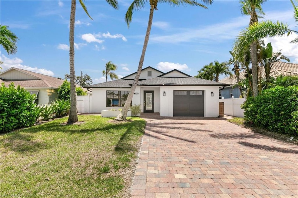 View of front of house with decorative driveway, s