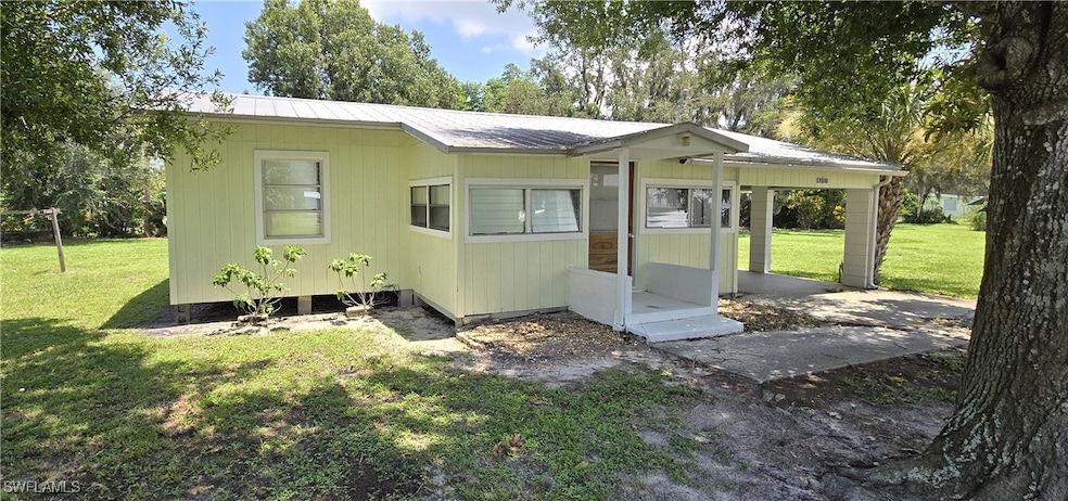 Rear view of property featuring a yard