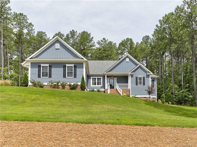 Custom ranch home sits elegantly back from the str