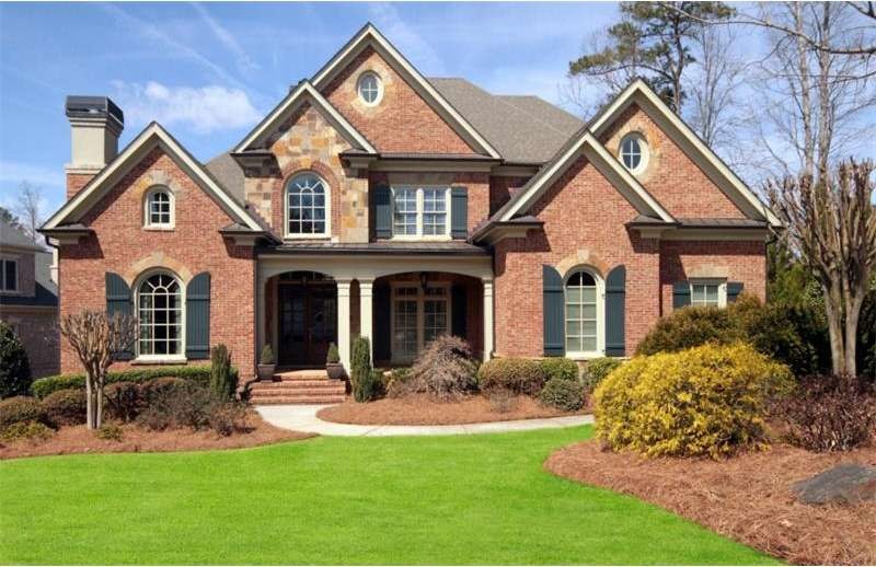 Stone and brick classic with inviting front porch.