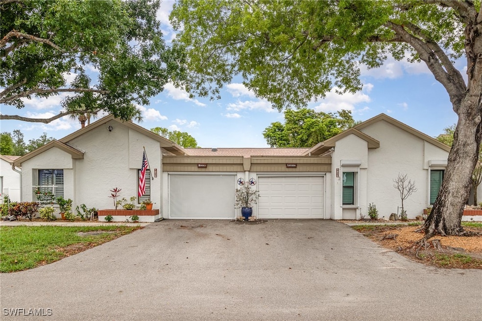 View of front facade with driveway, an attached ga
