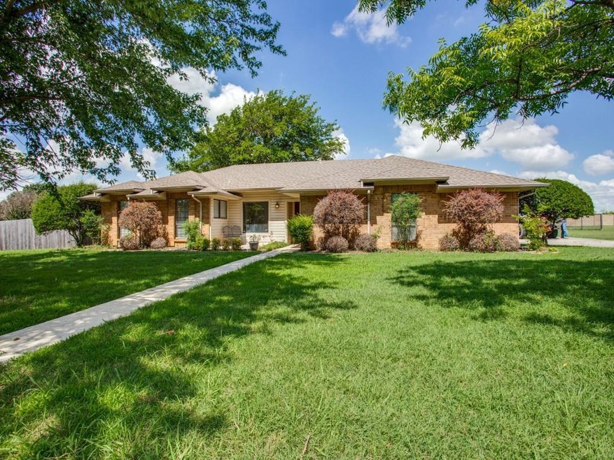 Beautiful curb appeal with huge trees, covered front porch, long sidewalk, multiple gables. Charming area at front porch for putting chairs, a bench, or larger flower pots/urns.