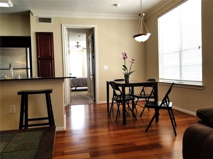 Open dining area with beautiful hardwood floors. F