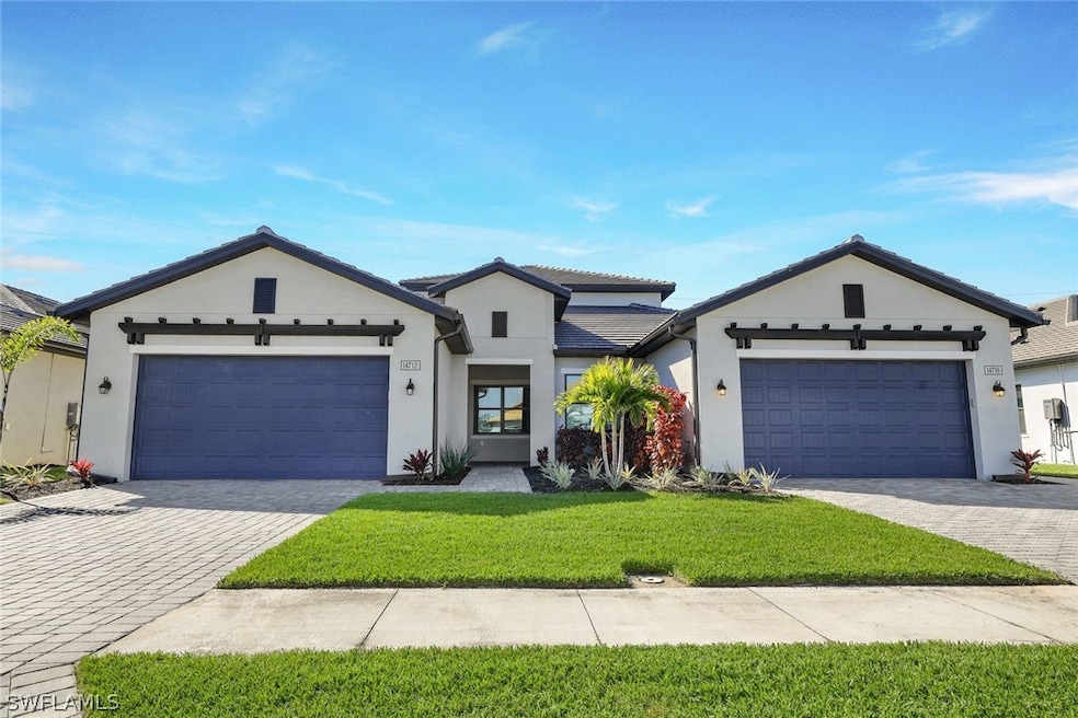 View of front of home with a garage and a front ya